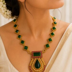 Jyothika long haram traditional Kerala bridal temple necklace featuring intricate coin motifs and ruby red stone accents