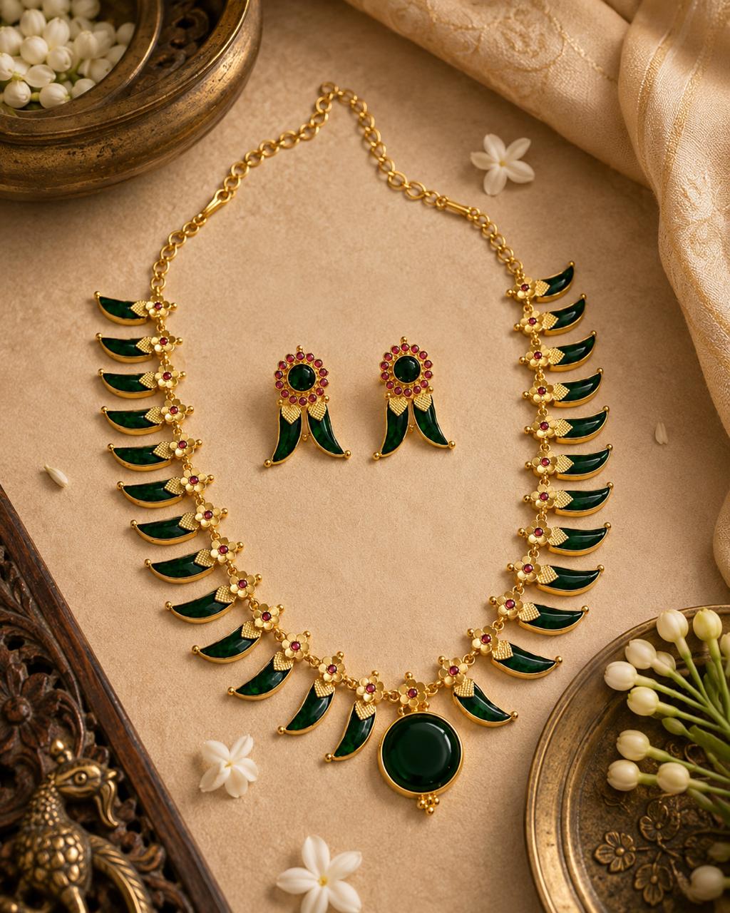 Premium Pulinakham necklace set featuring traditional tiger claw motifs with ruby and emerald stone accents